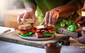 danish-crown-sandwich-and-hands-600x350px
